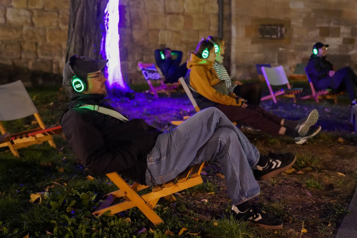 Kulturinsel Playtime © Daniela Wolf Menschen in Liegestühlen sitzend hören Musik über Kopfhörer